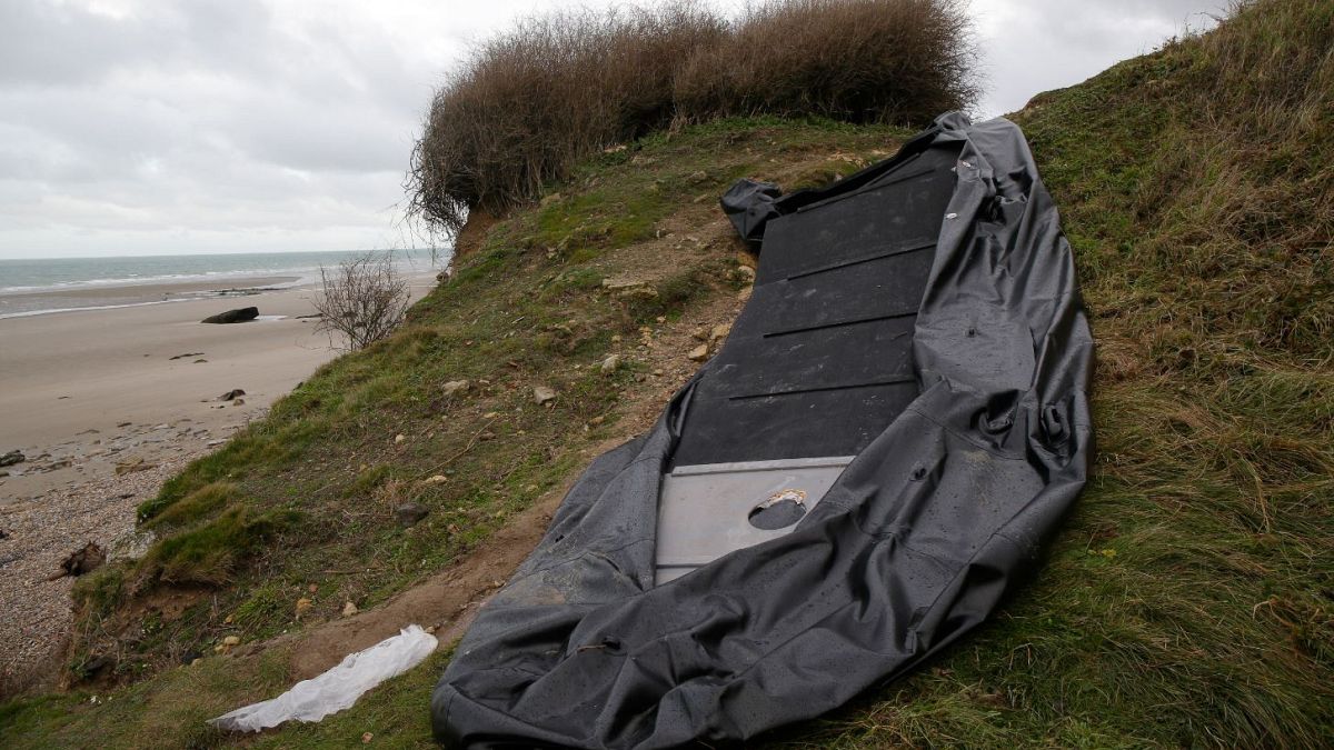 A damaged inflatable small boat is pictured on the shore in Wimereux, northern France.