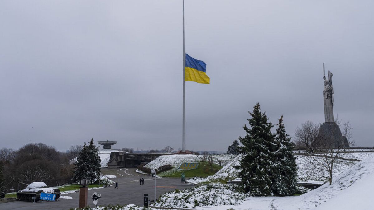 The Ukrainian flag flatters at half mast near the Ukrainian Motherland monument in Kyiv, Ukraine