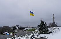 The Ukrainian flag flatters at half mast near the Ukrainian Motherland monument in Kyiv, Ukraine