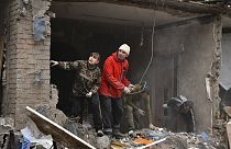 People work to remove debris from a damaged house after an overnight Russian shelling, in Sloviansk, Donetsk region, Ukraine