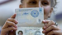 A Kosovo Albanian holds the country's first passport issued in Pristina in July 2008,