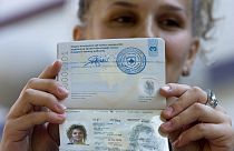 A Kosovo Albanian holds the country's first passport issued in Pristina in July 2008,