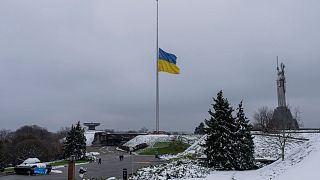 The Ukrainian flag flatters at half mast near the Ukrainian Motherland monument in Kyiv.