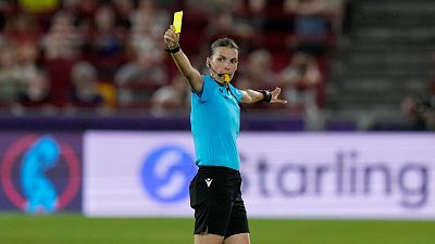 Referee Stephanie Frappart shows a yellow card during a Women Euro 2022 match