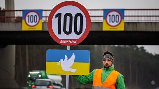 Greenpeace activists protest for temporary speed limits on German motorways.