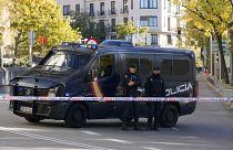 Police officers stand guard as they cordon off the area next to the U.S. embassy in Madrid, Spain, Thursday, Dec. 1, 2022