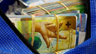 Bundles of unsorted Swiss franc banknotes lie in a transport bag at a Swiss bank in Zurich.