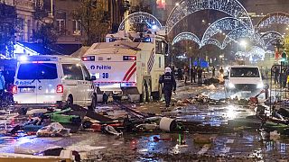 Police cars drive through the main boulevard in Brussels, 27 November as violence broke out during and after Morocco's 2-0 win over Belgium 
