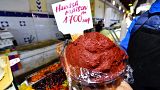 A shopkeeper shows a plate of Tunisian Harissa at the central market of the capital Tunis on December 1, 2022. 