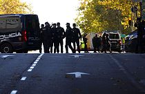 Police officers cordon off the area next to the U.S. embassy in Madrid, Spain, Thursday, Dec. 1, 2022