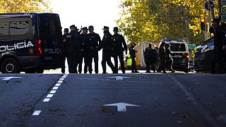 Police officers cordon off the area next to the U.S. embassy in Madrid, Spain, Thursday, Dec. 1, 2022