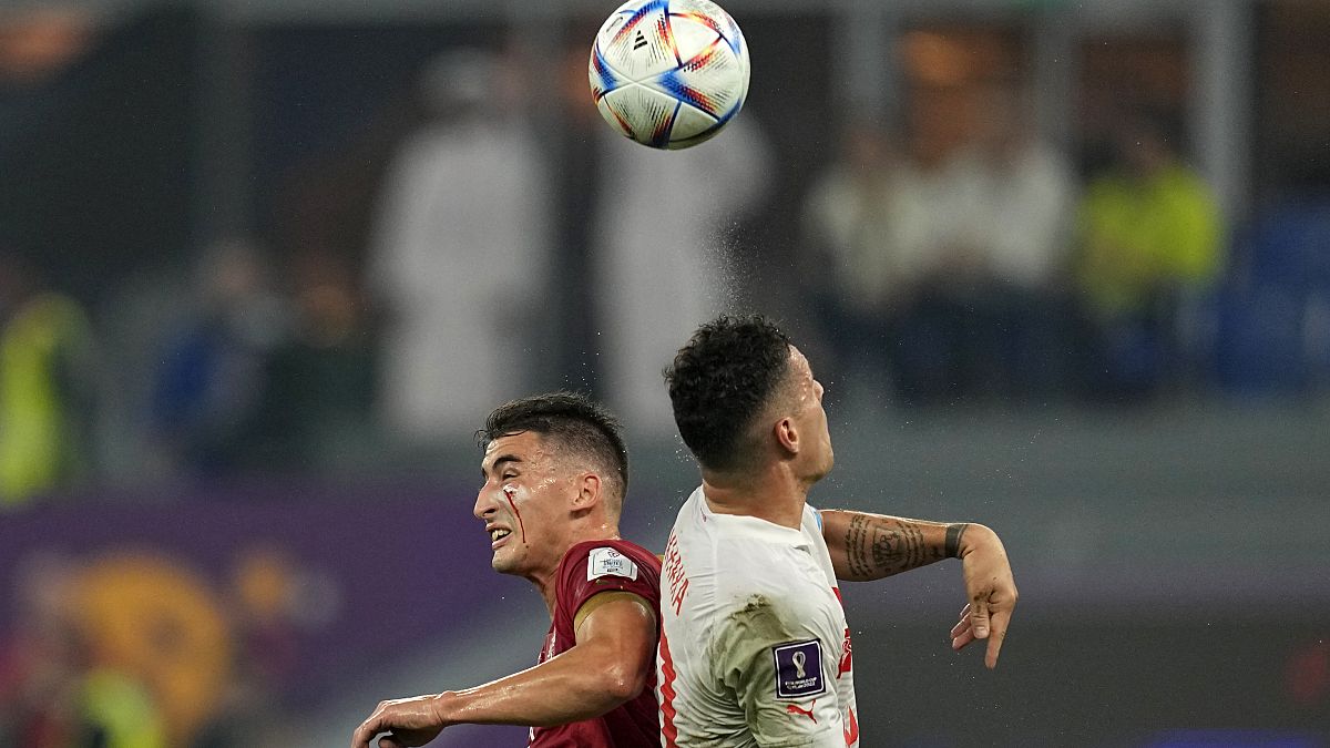 Serbia's Filip Duricic, left, and Switzerland's Granit Xhaka go for a header during the World Cup group G soccer match between Serbia and Switzerland.