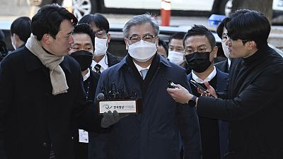 Former South Korean National Security Director Suh Hoon, center, arrives at the Seoul Central District Court in Seoul, 2 December 2022