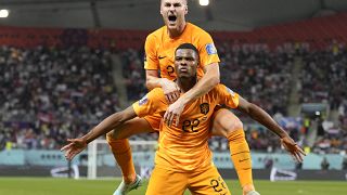 Denzel Dumfries of the Netherlands, bottom, is congratulated after scoring his side's 3rd goal during the World Cup round of 16 soccer match between the Netherlands and the US