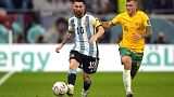 Argentina's Lionel Messi and Australia's Riley McGree fight for the ball during the World Cup round of 16 match between Argentina and Australia.