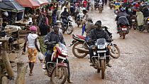 In this Aug. 8, 2015 photo, drivers ride motorbike taxis in the market in Kenema, eastern Sierra Leone