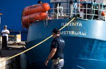 An Italian police officer stands by the Iuventa rescue ship run by German NGO Jugend Rettet (Youth Saves) arrives at the harbour of Trapani on August 4, 2017.