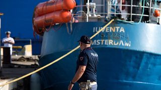 An Italian police officer stands by the Iuventa rescue ship run by German NGO Jugend Rettet (Youth Saves) arrives at the harbour of Trapani on August 4, 2017.