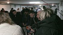 Ukrainians and UN officials in a bunker during an air raid in Kyiv