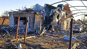 A damaged building and car are seen after a Russian strike in the village of Novosofiivka, in the Zaporizhzhia region, Ukraine, Monday, 5 December 2022.