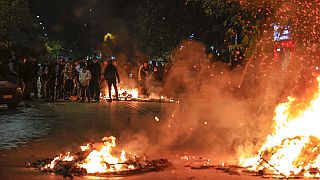 People blocking a main road set fire to rubbish bins outside the Ippokrateio General Hospital, in Greece's second largest city of Thessaloniki, on Monday, Dec 5, 2022. 