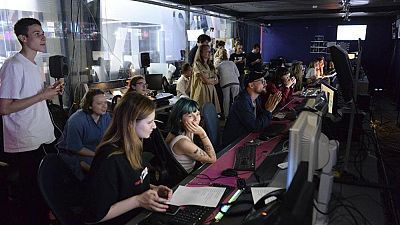 Journalists work in a news room of the Dozhd (Rain) TV channel in Moscow, Russia, Friday, Aug. 20, 2021. AP Photo/Denis Kaminev