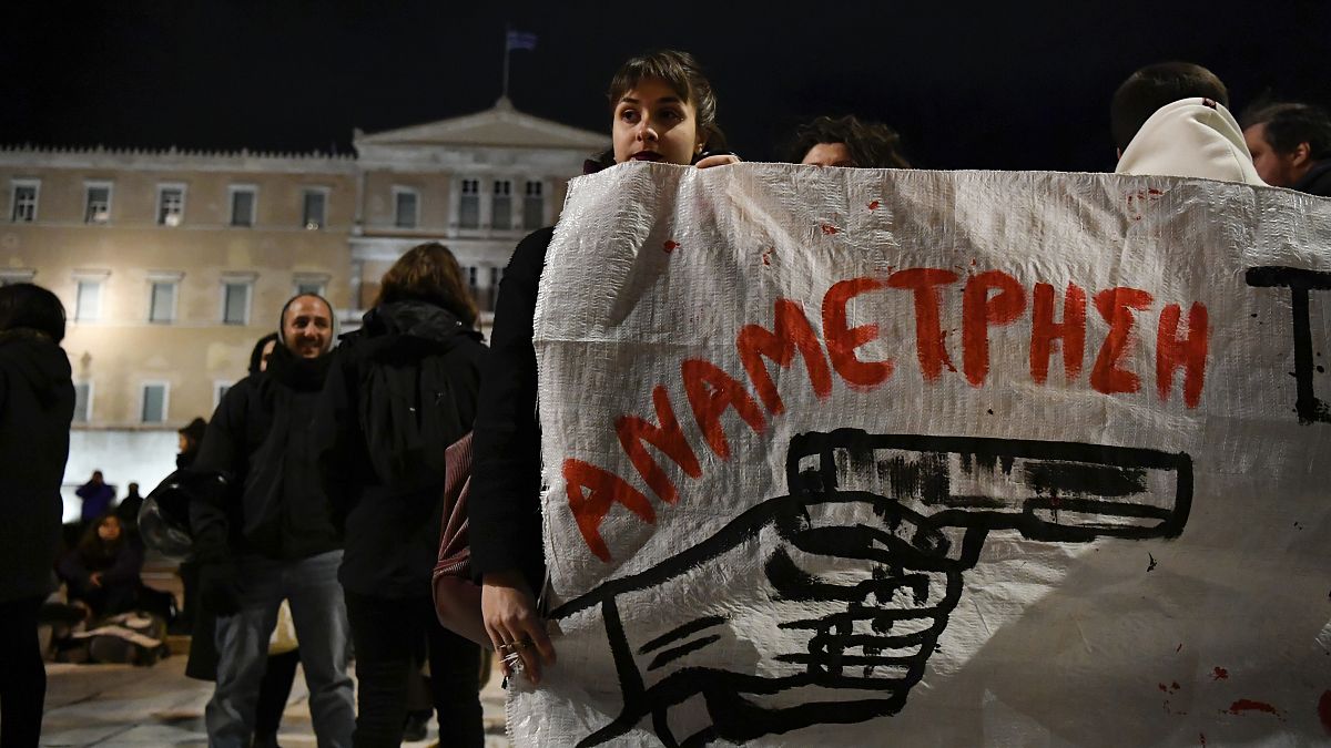 متظاهرون أمام يحملون لافتة كتب عليها باللغة اليونانية "مواجهة" أثناء احتجاجهم على إطلاق النار على  شاب يبلغ من العمر 16 عامًا 