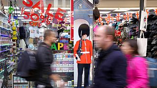 FILE - Pedestrians pass a souvenir shop on Oxford Street in London, on Nov. 11, 2022.