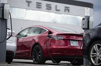 A 2021 Model 3 sedan sits in a near-empty lot at a Tesla dealership in Littleton, Colo. June 27, 2021.