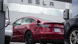 A 2021 Model 3 sedan sits in a near-empty lot at a Tesla dealership in Littleton, Colo. June 27, 2021.