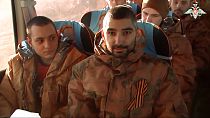 A group of Russian soldiers sit in a bus after being released in bilateral prisoner swap