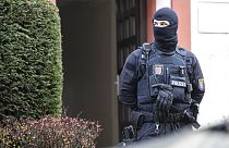 Police officers stand by a searched property in Frankfurt during a raid against so-called 'Reich citizens' in Frankfurt, Germany, Wednesday, Dec. 7, 2022.