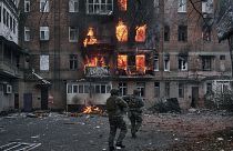 Ukrainian soldiers rush to an apartment fire after the Russian shelling in Bakhmut, Donetsk region.