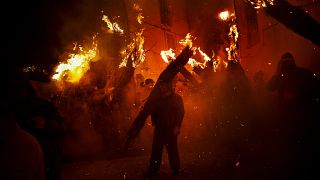 Villagers hold burning brooms during 'Los Escobazos' Festival in Jarandilla de la Vera, Spain