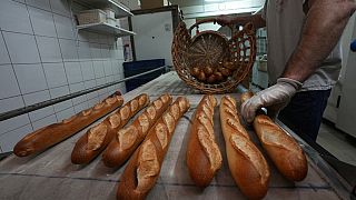 A Versailles baker empties his oven