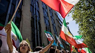 Supporters of Iranian opposition leader Maryam Rajavi shout slogans during a demonstration in Brussels.