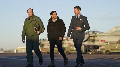 Air Chief Marshal Mike Wigston, left and Station Commander for RAF Coningsby Billy Cooper walk with UK PM Rishi Sunak during his visit to RAF Coningsby. Friday, 9 Dec. 2022.