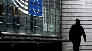 A man walks near the entrance of the European Parliament in Brussels on December 9, 2022.