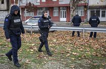 Kosovo police officers guard the offices of the Central Election Committee in ethnically divided town of northern Mitrovica, 9 December 2022