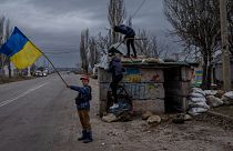 Ukrainian children play at an abandoned checkpoint in Kherson, southern Ukraine, Wednesday, Nov. 23, 2022.