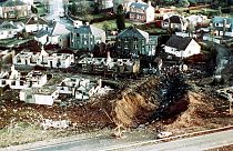  wrecked houses and a deep gash in the ground in the village of Lockerbie, Scotland, after the Lockerbie bombing.