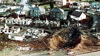  wrecked houses and a deep gash in the ground in the village of Lockerbie, Scotland, after the Lockerbie bombing.