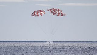 The Orion capsule is seen Sunday, December 11, 2022, parachuting into the Pacific off Mexico to conclude a dramatic 25-day test flight.