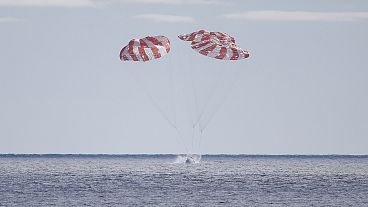 The Orion capsule is seen Sunday, December 11, 2022, parachuting into the Pacific off Mexico to conclude a dramatic 25-day test flight.