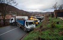 Heavy vehicles parked by local Serbs block the road in the village of Rudare, northern Kosovo on Sunday, Dec. 11, 2022.