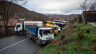 Heavy vehicles parked by local Serbs block the road in the village of Rudare, northern Kosovo on Sunday, Dec. 11, 2022. 