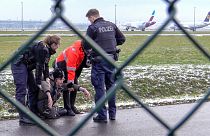 Activists protesting against cheap air travel glued themselves to Munich airport's runway on 8 December 2022.