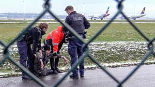 Activists protesting against cheap air travel glued themselves to Munich airport's runway on 8 December 2022.