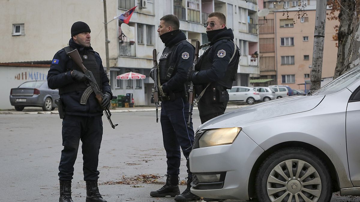 Kosovo police officers patrol in a mixed community neighborhood in the ethnically divided town of Mitrovica, in northern Kosovo on Monday, Dec. 12, 2022.