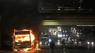 Simpatizantes del presidente brasileño, Jair Bolsonaro, se enfrentan con la policía incendiando varios vehículos en Brasilia, Brasil, el lunes 12 de diciembre de 2022.